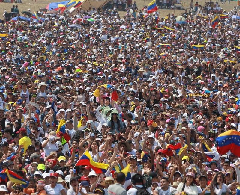 People attend the Venezuela Aid Live concert at the Tienditas border bridge in Cucuta, Colombia, on Friday. The concert, "Venezuela Aid Live," has been promoted by the billionaire Richard Branson and has the participation of at least 32 artists from a dozen countries. It aims to promote humanitarian aid to support Venezuelans affected by the crisis in their country. Photo by Ernesto Guzman Jr./ EPA-EFE