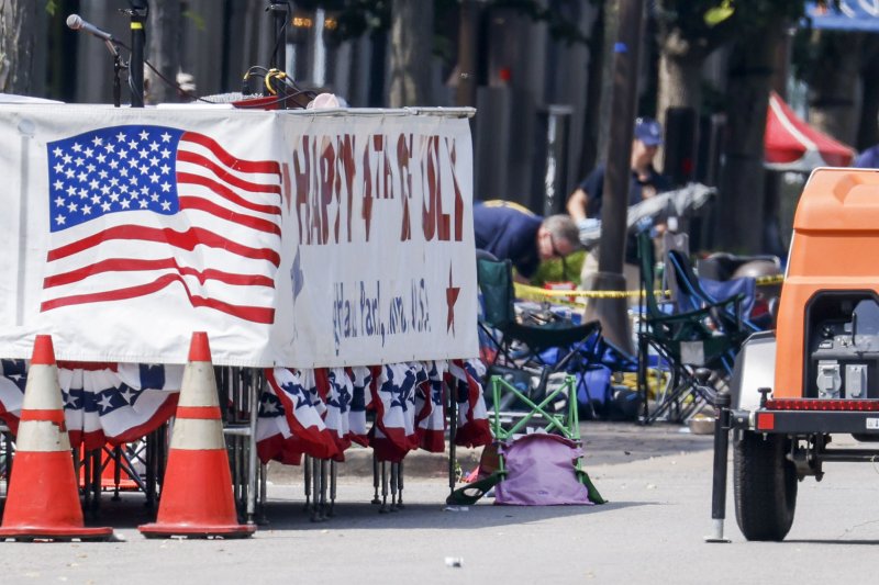 Police near the parade grand stand continue their investigation at the scene of a mass shooting at a 4th of July celebration and parade in Highland Park, Ill., on Tuesday. Photo by Tannen Maury/EPA-EFE