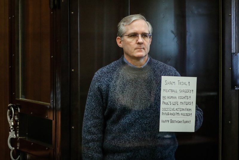 U.S. citizen Paul Whelan holds up a sign denouncing the legal proceedings against him as he stands inside the defendant's cage at his espionage trial in Moscow on June 15, 2020. He was visited in prison Thursday by U.S. Ambassador to Russia Lynne Tracy. File Photo by Yuri Kochetkov/EPA-EFE