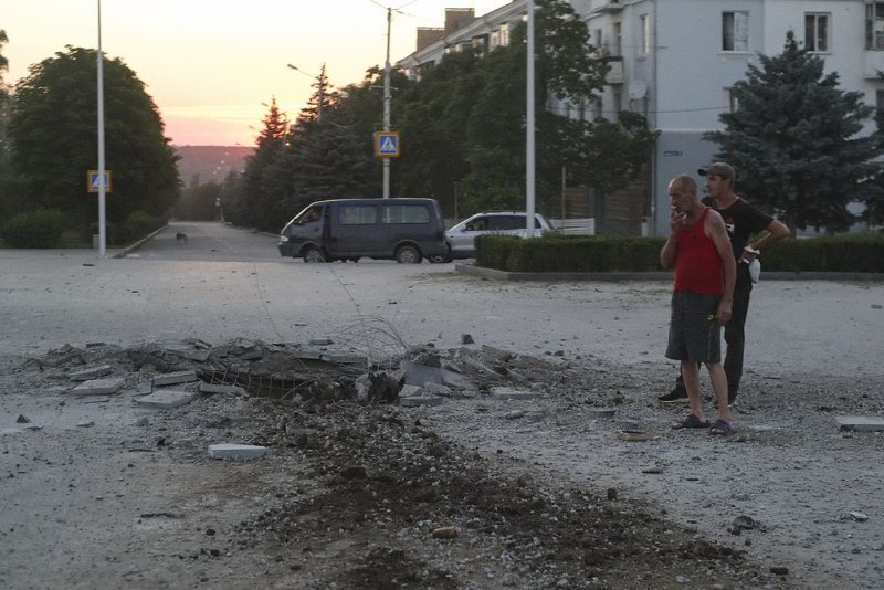 Locals at the scene of a crater caused by the downing of a Russian missile by Ukrainian defenders in downtown Kramatorsk in the Donetsk area of Ukraine on Friday. Photo by George Ivanchenko/EPA-EFE