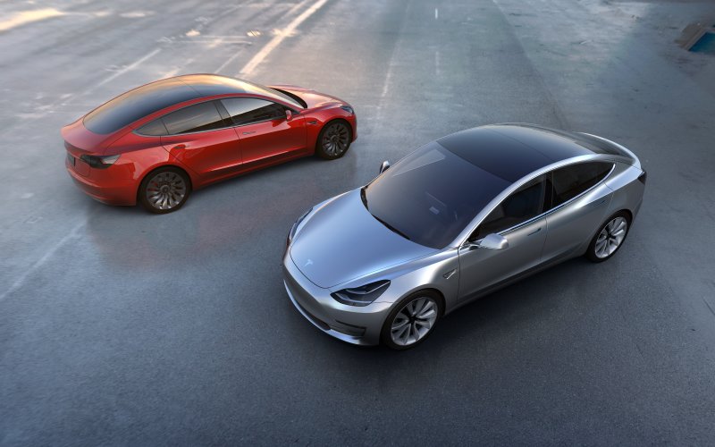 Tesla's Model 3 is meant to be the company's entry into the mass market, but production bottlenecks have frustrated the more than 500,000 people who put down deposits on the cars. Researchers say, however, that what is really holding back mass adoption of electric vehicles is the cost and range of current battery technology. Photo courtesy of Tesla/EPA