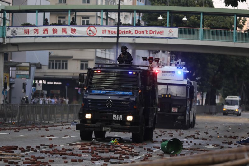 Police vehicles move on pro-democracy protesters during clashes outside the Hong Kong Polytechnic University in Hong Kong Monday. Photo by Fazry Ismail/EPA-EFE&nbsp;