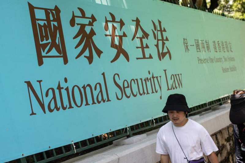 Pedestrians walk past a billboard for the National Security Law in Hong Kong, China, on July 15, 2020. Journalists in Hong Kong have said the national security law has caused press freedom to deteriorate. File Photo by Jerome Favre/EPA-EFE
