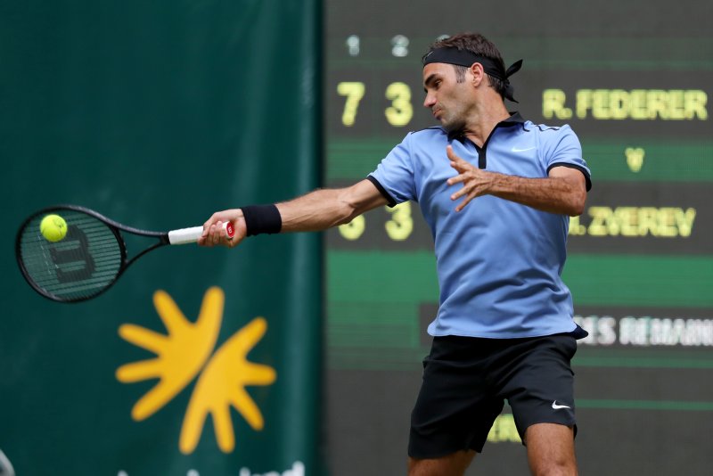 Roger Federer hits a return in his second round match against Mischa Zverev of Germany at the ATP tournament in Halle, Germany. EPA/TYLER LARKIN