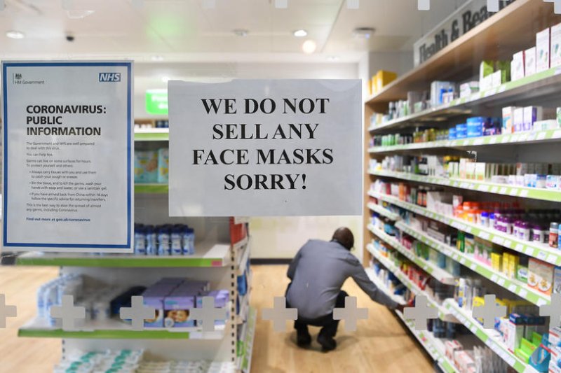 A notice is seen on March 9 at a pharmacy in St. Thomas' Hospital in London, Britain, advising visitors concerned about the coronavirus outbreak that they have no protective face masks for sale. File Photo by Andy Rain/EPA-EFE
