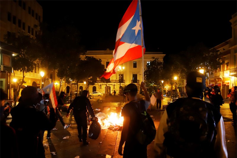Demonstrators clash with police late Wednesday during a protest in San Juan, Puerto Rico. Thousands have rallied to demand the resignation of Gov. Ricardo Rosello. Photo by Thais Llorca/EPA-EFE