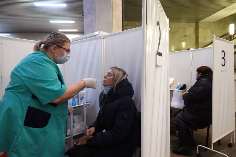 A woman undergoes COVID-19 testing at an express test point in Moscow on Wednesday. Authorities approved non-working week through Sunday in Russia to curb the fast spreading of coronavirus infection. Photo by Maxim Shipenkov/EPA-EFE