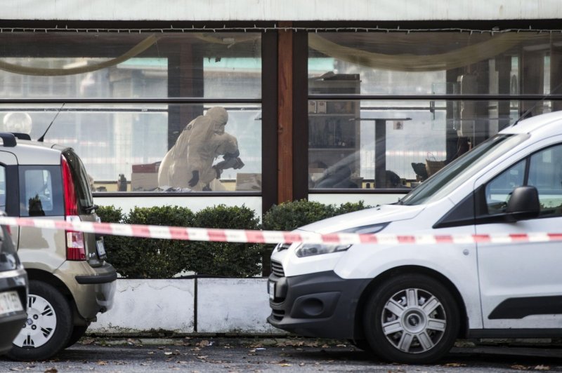 Police secure the crime scene where three people were killed and four others were injured during a shooting that took place in a bar, as a meeting of residents of an apartment block in Rome, Italy, took place Sunday. The gunman is being help by police. Photo by Angelo Carconi/EPA-EFE