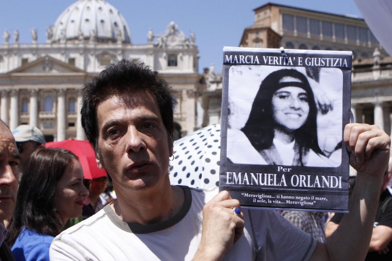 Pietro Orlandi, the brother of mysteriously missing Emanuela Orlandi, holds a photo of his sister in St. Peter's Square, Vatican City, in June 2012, when he and supporters highlighted her disappearance. File Photo by Serena Cremaschi/EPA