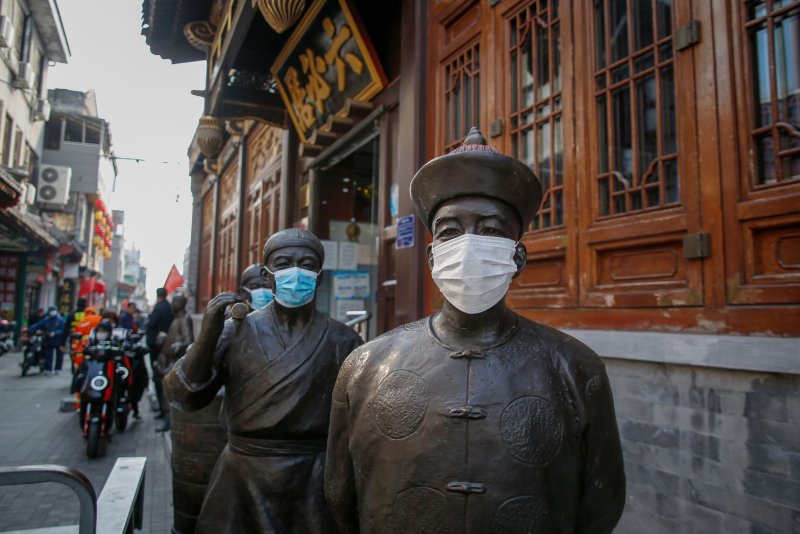 Statues wear face masks at a shopping district in Beijing, China, on Friday. China continues its travel restrictions and lockdowns a week ahead of the Communist Party congress. Authorities have banned people from leaving Xinjiang while the government. Photo by Mark R. Crinstino/EPA-EFE