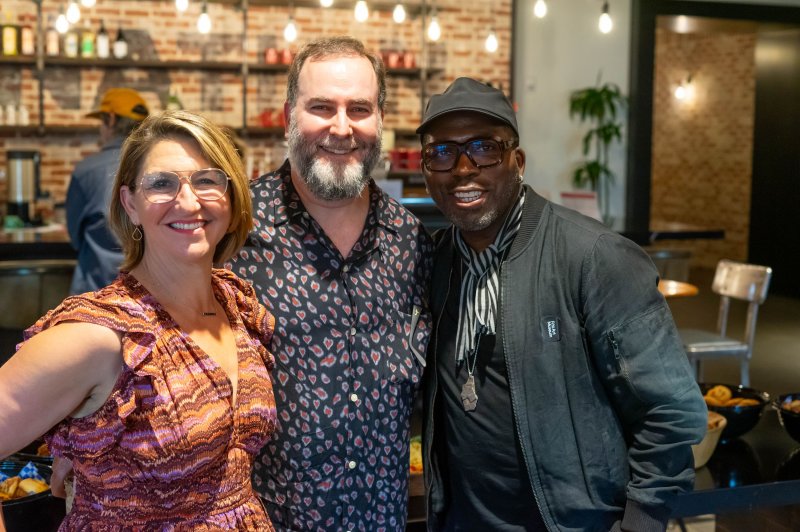 Artist Derrick Adams, right, is seen with Artville co-founder Samantha Saturn and her husband, Steve Kravitz, in the Live Nation offices in Nashville for the festival. Photo by Adam Schrader/UPI