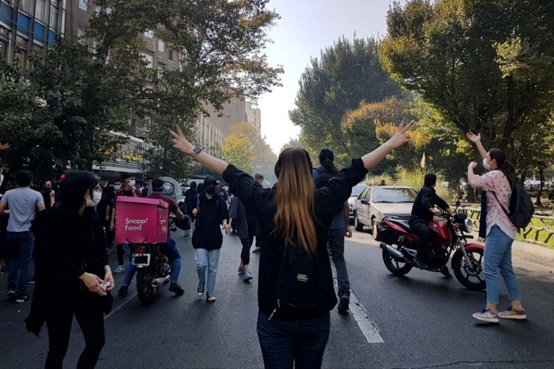 Protesters block a road in Tehran during a demonstration October 1 over the death of Mahsa Amini, who died after being arrested for a dress code violation. File Photo by EPA-EFE