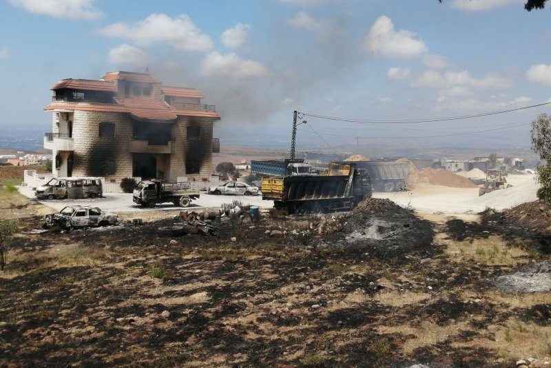 A view of a burnt house and vehicles of the man who owned the fuel tank that exploded in Akkar, northern Lebanon, on Sunday. Photo by EPA-EFE