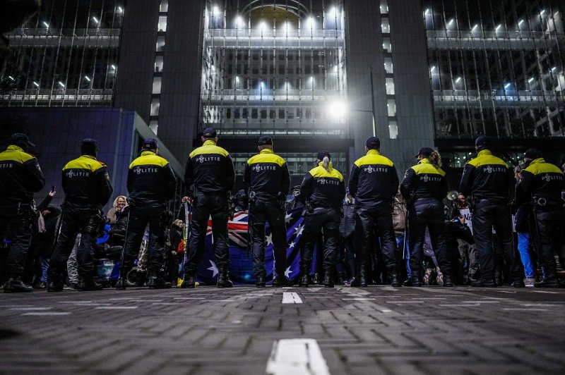 Police in The Hague, Netherlands, confront people protesting against the Dutch government's move on Saturday to institute a hard lockdown through at least January 14 to curb the rapid spread of the Omicron variant. Photo by Phil Nijhuis/EPA-EFE