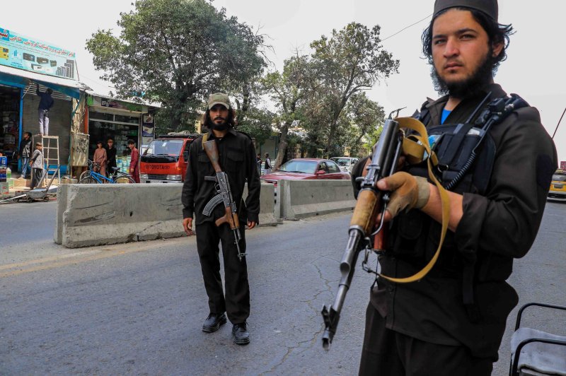Armed members of the ruling Taliban stand guard on Thursday near a mosque in Kabul, Afghanistan, that was targeted by a suicide attack. Authorities said that nearly two dozen people were killed in the explosion. Photo by EPA-EFE