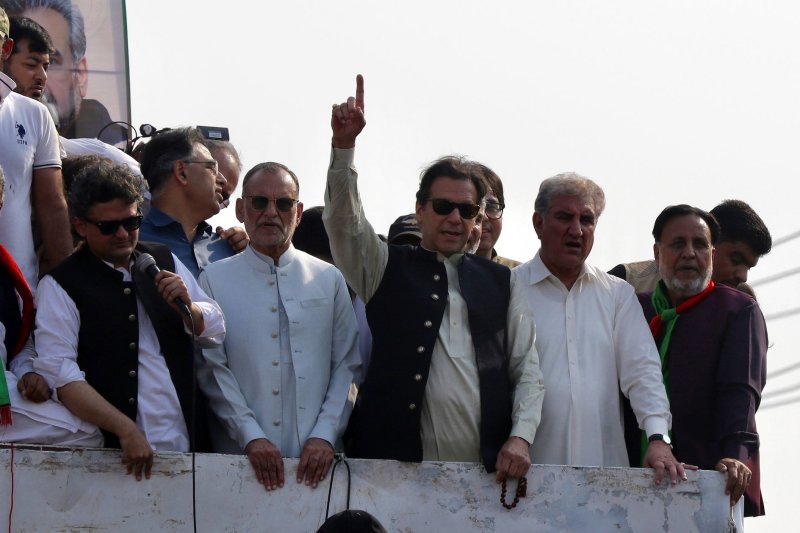 Pakistan's former Prime Minister Imran Khan (C) waves to supporters during a protest march to Islamabad on Saturday. He was shot in the leg on Thursday. Photo by Rahat Dar/EPA-EFE