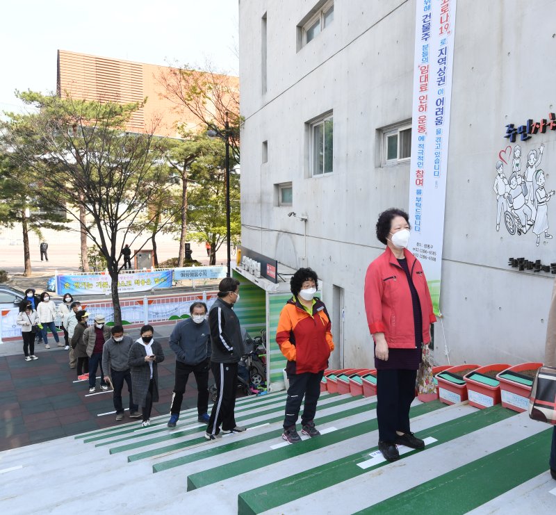 South Korean voters wait in line to cast ballots Friday while maintaining social distancing at a polling station in Seoul. The general election is Wednesday. Photo by Jeon Heon-Kyun/EPA-EFE