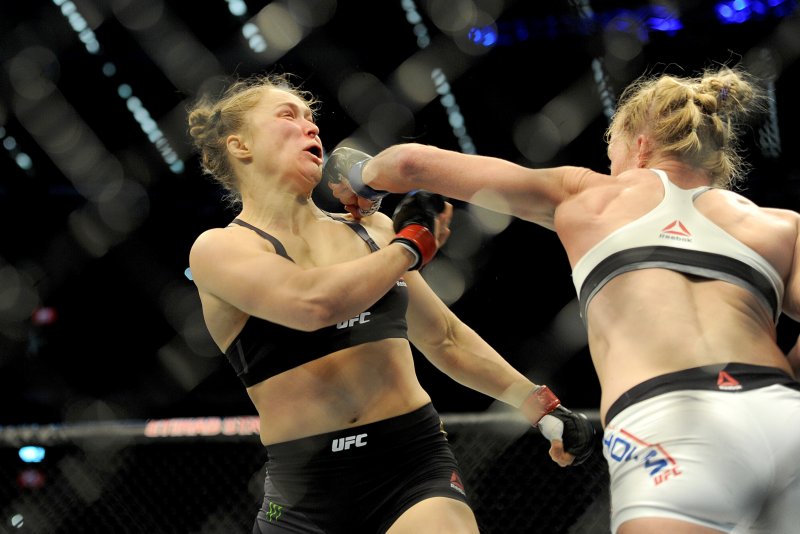 Holly Holm strikes defending champion Ronda Rousey (left) in the Women's Bantamweight Bout during the UFC 193 Australia event in 2015 at Etihad Stadium in Melbourne. Photo by Joe Castro/EPA
