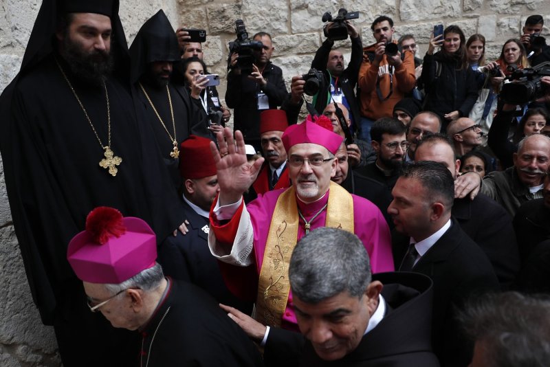 Pierbattista Pizzaballa (C), the Latin Patriarch of Jerusalem, arrives Saturday at Manger Square for the annual Christmas Eve procession in the West bank town of Bethlehem. Photo by Atef Safadi/EPA-EFE
