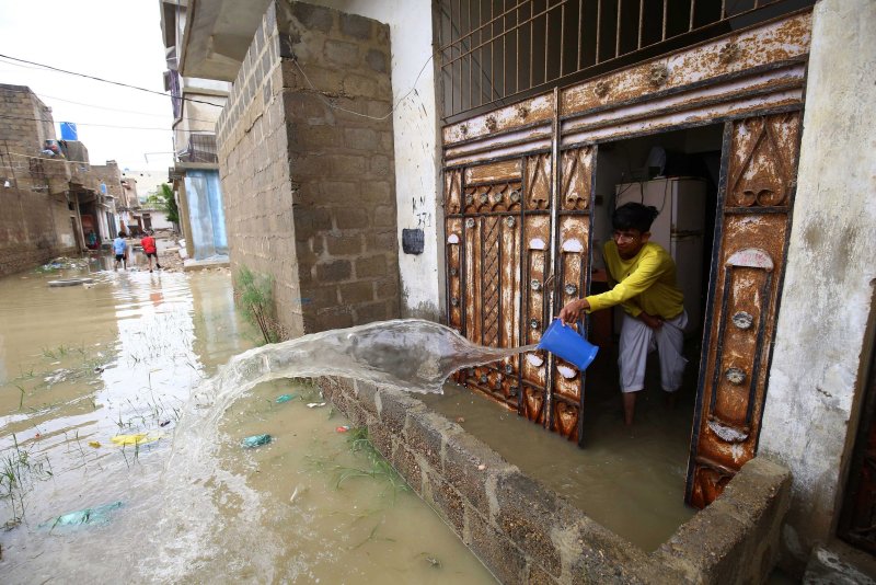 Residents drain water from their homes after heavy monsoon rains in Karachi, Pakistan, on July 11. File Photo by Shahzaib Akber/EPA-EFE