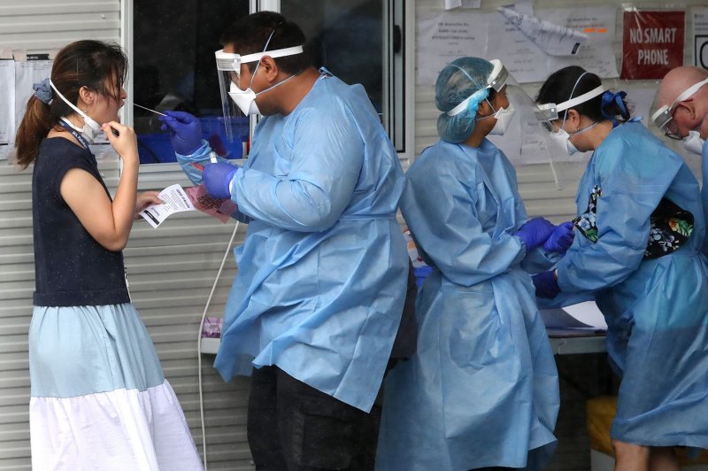 Health workers are seen at a COVID-19 testing site in Brisbane, Australia, on January 7. File Photo by Jono Searle/EPA-EFE