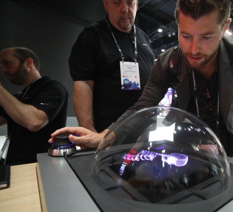 An attendee uses an controller to interface with a 5G holographic video at the GSMA Mobile World Congress Americas at the LA Convention Center in Los Angeles, Calif., on September 12. Photo by Mike Nelson/EPA-EFE