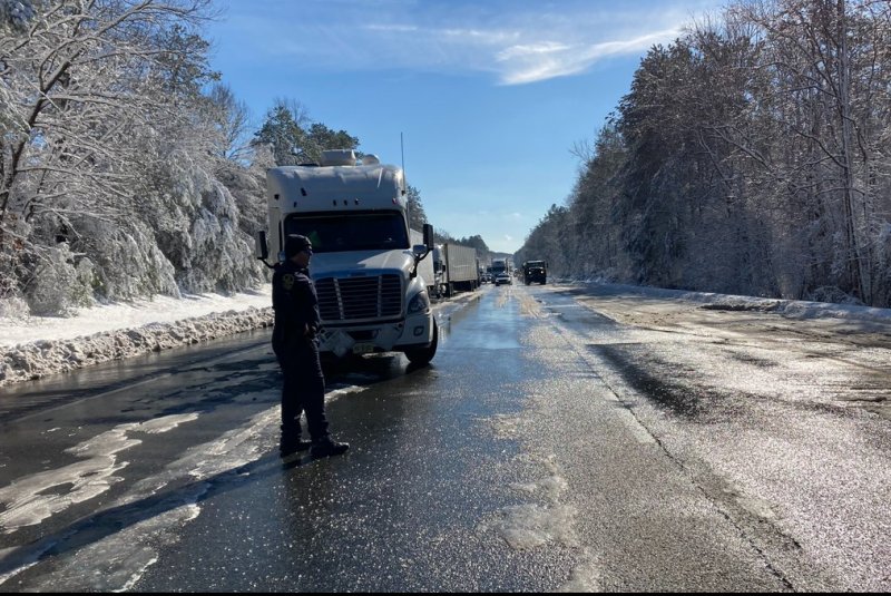 Virginia State Police direct traffic at an emergency crossover to get traffic moving from Interstate 95 in Caroline County, Va., Tuesday, after a snow storm shut down the highway. Photo courtesy of Virginia State Police/Twitter