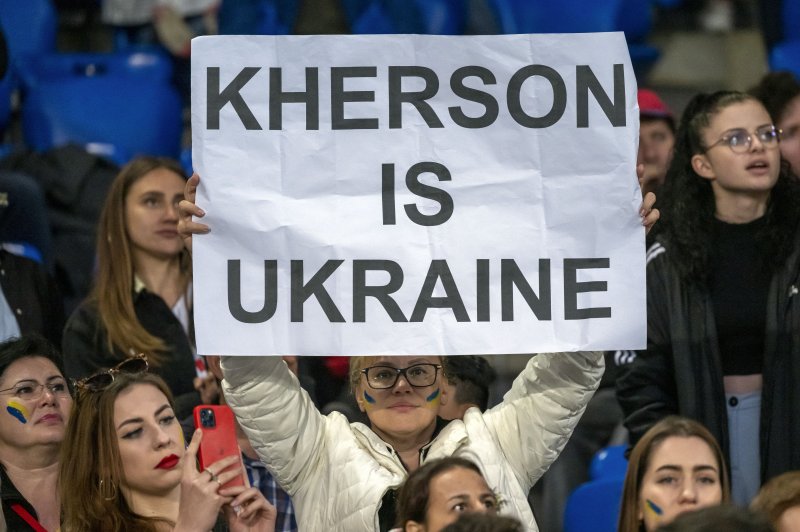 A woman holds a poster with the inscription Kherson Is Ukraine during the Match for Peace charity soccer match between Switzerland's FC Basel 1893 and Ukraine's FK Dynamo Kiev. Russian-appointed authorities in Kherson on Wednesday announced plans to annex the city. Photo by Georgios Kefalas/EPA-EFE