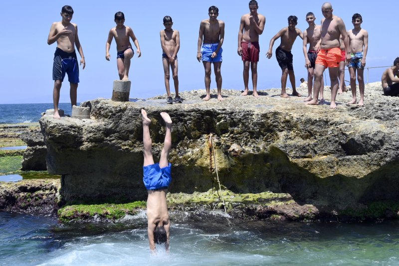 Swimmers dive into the Mediterranean Sea, where rapid warming has caused ocean temperatures in the region to soar to unprecedented levels over the past year, according to scientists. File Photo by Wael Hamzeh/EPA-EFE