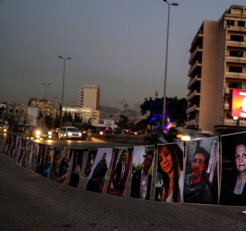 Pictures of victims of the Beirut port explosion hang in the street opposite of a Christmas tree set up in their memory in Beirut, Lebanon on Monday. Photo by Nabil Mounzer/EPA-EFE