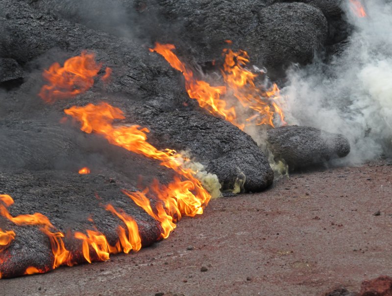 A new lobe of lava burned along Cemetery Road/Apaʻa Street after it crossed early morning on Nov. 9, 2014. Lava began flowing on June 27th from Kilauea Volcano on Hawaii's Big Island, threatening the town of Pahoa. UPI/USGS