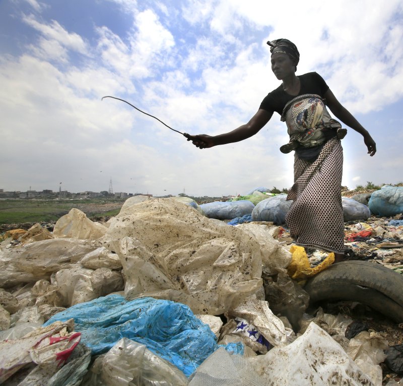 Researchers say the problem of plastic waste will only get worse without changes to waste management and global use of less plastic. Pictured, an Ivorian woman collects plastic bottles to sell for recycling from the general waste at the Akouedo recycling depot and landfill site in Abidjan, Ivory Coast, in 2018. Photo by Legnan Koula/EPA-EFE
