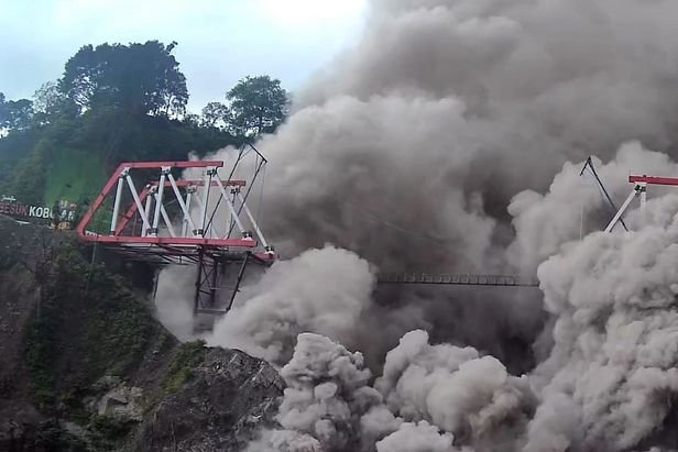 A handout photo made available by the Indonesian National Board for Disaster Management shows volcanic materials from Mount Semeru volcano hitting a bridge following an eruption on Sunday. Photo courtesy EPA-EFE/BNPB