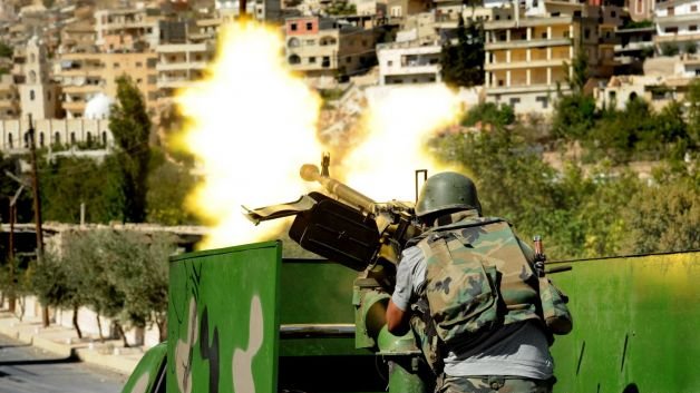 In this Sept. 7, 2013 photo released by the Syrian official news agency SANA, a Syrian military soldier fires a heavy machine gun during clashes with rebels in Maaloula village, northeast of the capital Damascus, Syria. Maaloula, a Christian town with holy sites for Muslims and Christians alike, sits 34 miles north of the Syrian capital Damascus. It had been under government control until a rebel attack last week initially repelled forces loyal to Syrian President Bashar Assad. Photo: SANA/UPI
