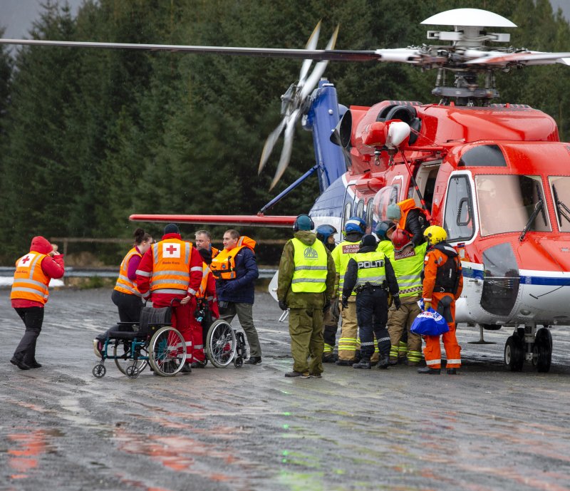 Rescue services help passengers get out of a helicopter after they have been evacuated from the Viking Sky cruise ship in Hustadvika, Norway, on Sunday. Photo by Svein Ove Ekornesvag/EPA-EFE