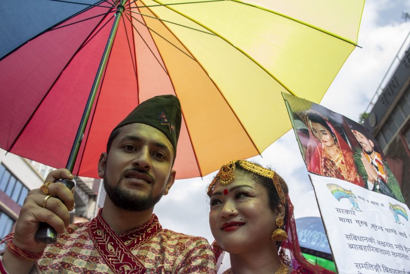Nepal’s Maya Gurung (R) and Surendra Panday wear traditional attire as they take part in a gay Pride parade in Kathmandu, Nepal, in August. On Wednesday, their marriage became the first officially recognized by the South Asian nation. File Photo by Narendra Shrestha/EPA-EFE