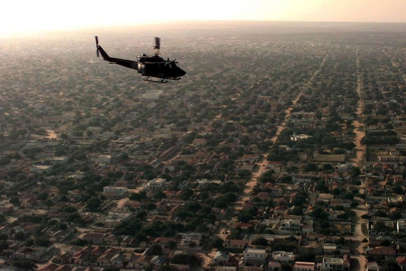 A U.S. Marine UH-1N "Huey" helicopter flies over a Mogadishu residential area on a patrol mission to look for signs of hostilities on December 1, 1992. On October 3, 1993, the two-day Battle of Mogadishu began during the Somali Civil War, killing 19 Americans and between 200 and 300 Somalis. File Photo courtesy of the U.S. Air Force