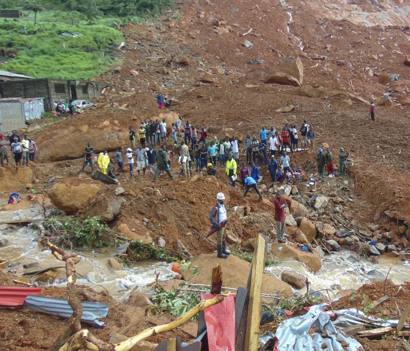 Residents of Sierra Leone view damage Tuesday caused by a mudslide in the suburb of Regent, behind Guma Reservoir in Freetown. Photo by Ernest Henry/EPA