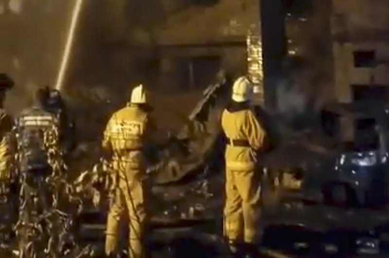 A handout still image taken from video provided by the Krasnodar Kray Governor Viniamin Kondratiyev shows Russian firefighters extinguishing the fire in the residential building on the crash site of the Russian Su-34 bomber in Yeysk, Krasnodar Krai, Russia, on Monday. Handout Photo by Viniamin Kondratiyev/EPA-EFE
