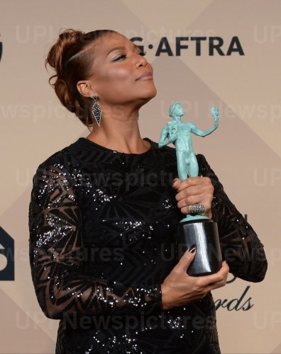 Queen Latifah wins an award backstage at the 22nd annual Screen Actors Guild Awards